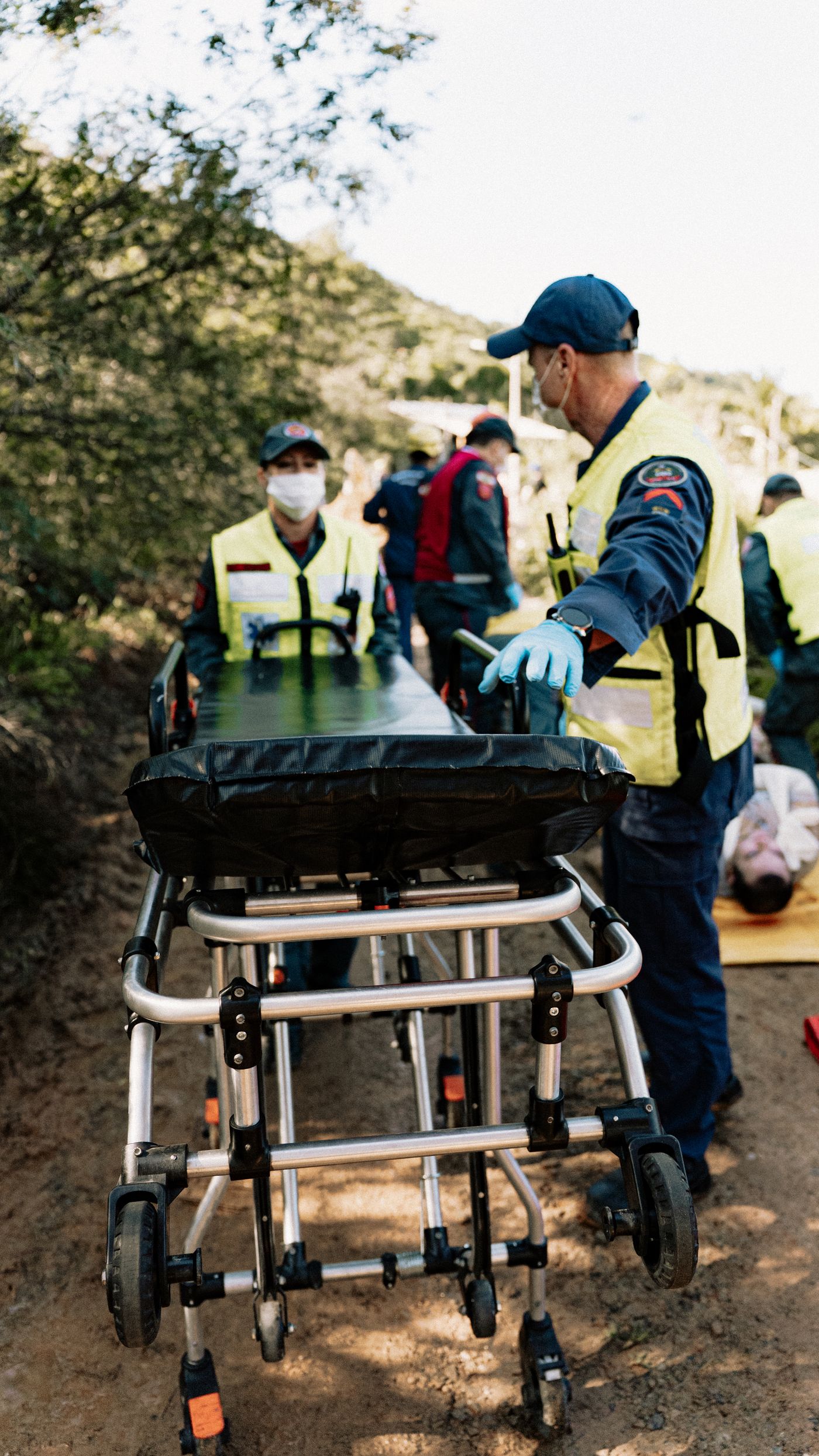 An emergency response team running a medical simulation with a stretcher