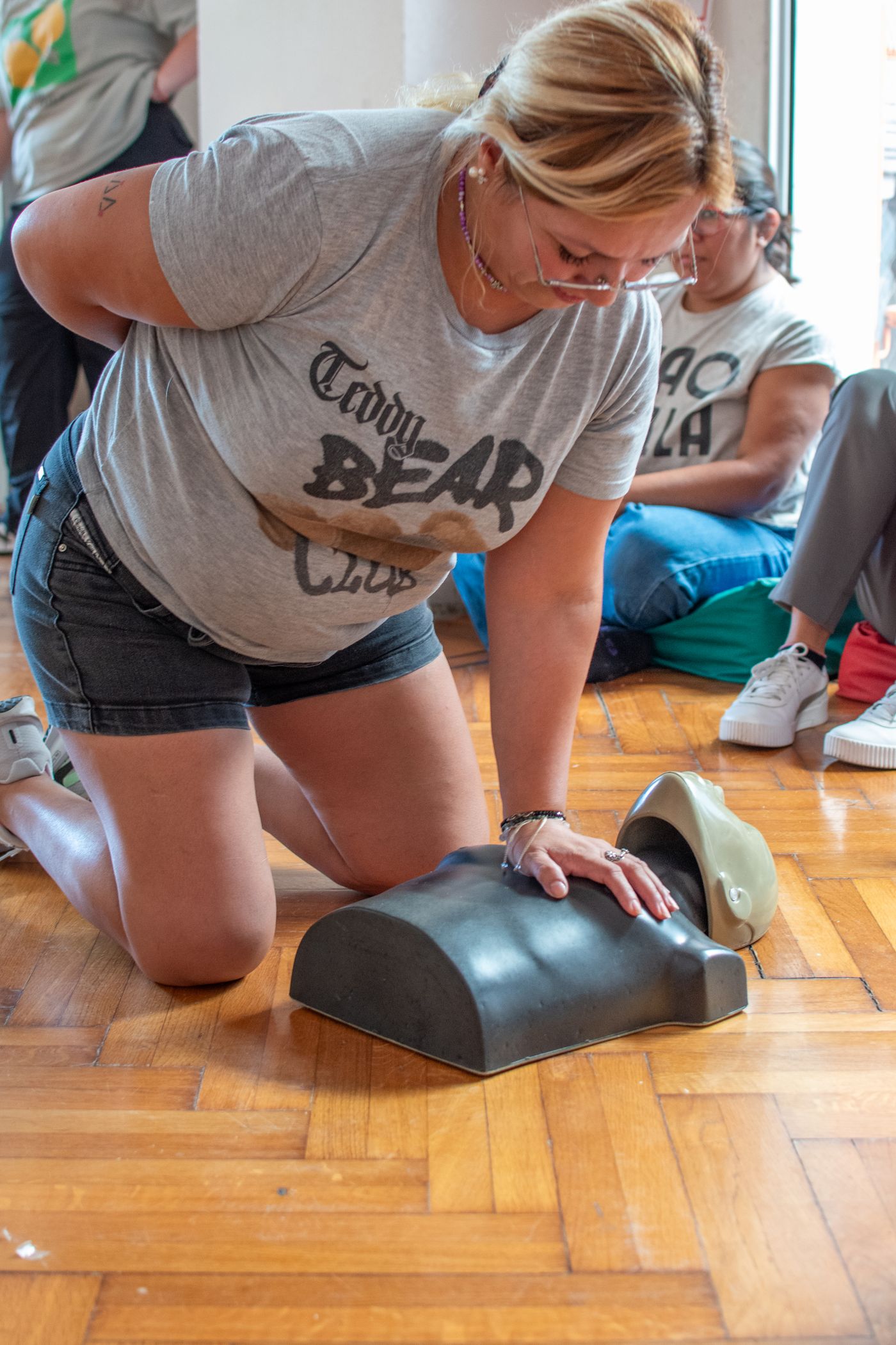 A student practising CPR compressions during a training session